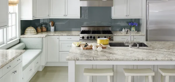 a kitchen with white cabinets and white countertops